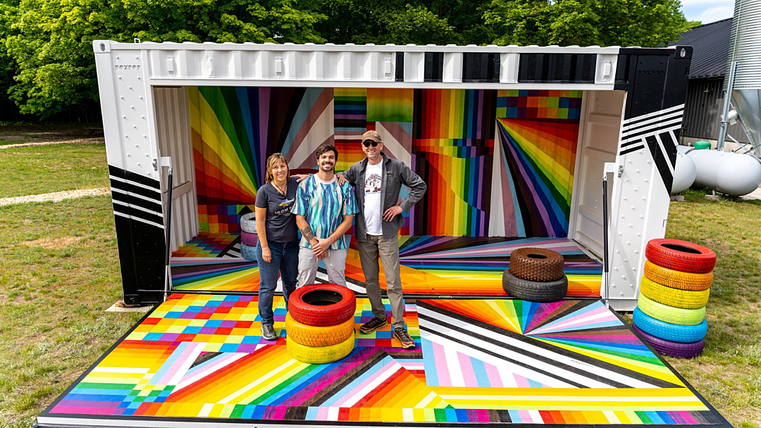 A colorful BoxPop 20 custom shipping container being used as an art installation for Up North Pride event