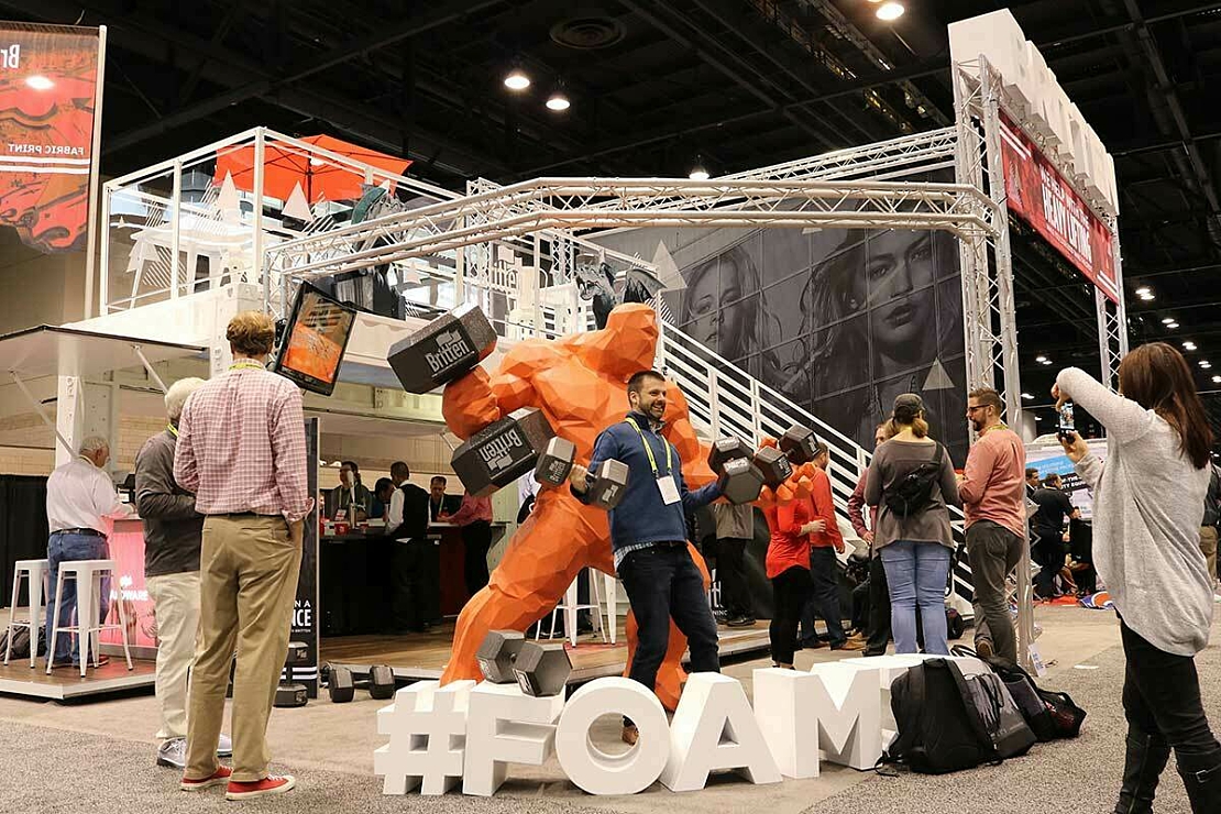 People taking selfies at the Global Shop Tradeshow