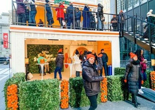 People posing in front of the Tropicana BoxPop activation